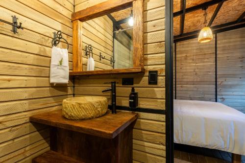 Un baño con lavabo en una cabaña de troncos en Unique, en Guatapé