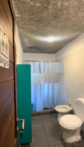 a bathroom with two toilets and a shower at Balconada Rooms in La Paloma