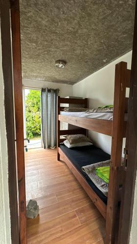 a room with two bunk beds and a window at Balconada Rooms in La Paloma