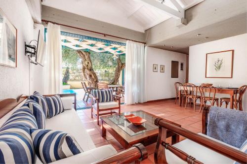 a living room with a couch and a table at Barbati Beach - Villa Ithika in Barbati