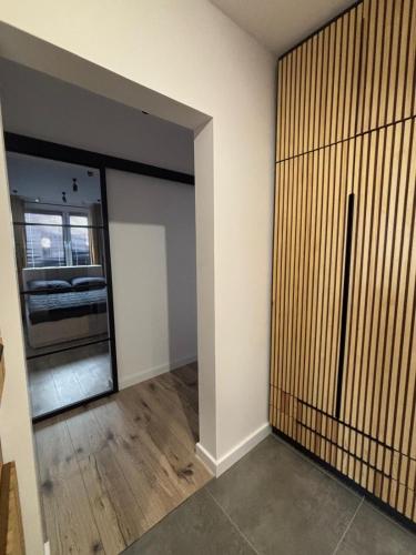 an empty room with a sliding door and a bedroom at Loft Re Design Apartament in Głogów