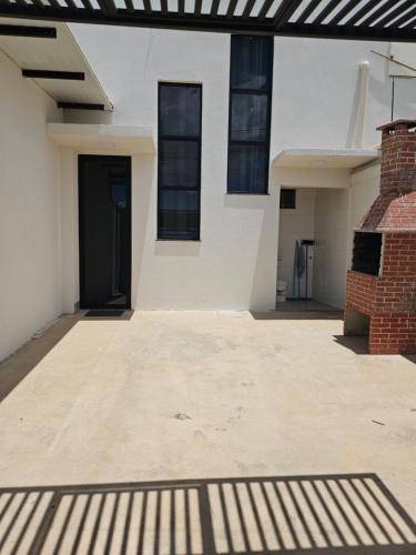 a house with a driveway with a black door at Apto Bell Valle I in Sorriso