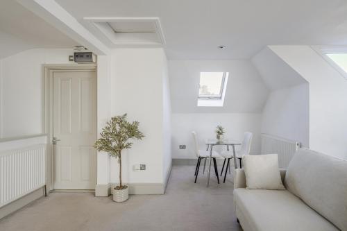 a white living room with a couch and a table at Moulsham Apartments in Chelmsford - Apartment C, Apartment E - Free WiFi & Free Parking - Long Stays Welcome in Chelmsford