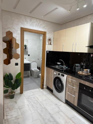 a kitchen with a washer and dryer in it at Studio Stadium morocco for family in Mohammedia