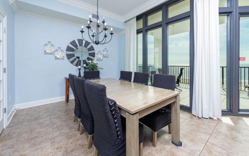 a dining room with a wooden table and chairs at The Oasis 405 formerly Phoenix West II 405 condo in Romar Beach