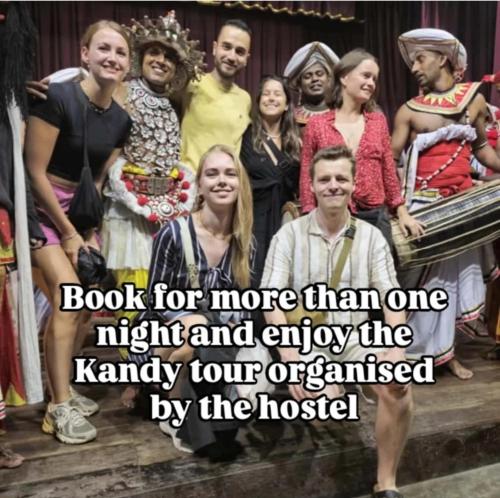 a group of people posing for a picture on a stage at Catch The Ella Train Hostel in Kandy