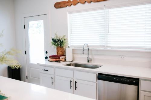 a white kitchen with a sink and a window at Mid-Term Discounts - Near Downtown, UGA, Hospital in Athens