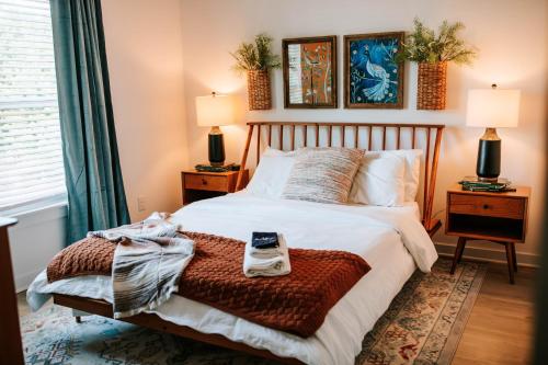 a bedroom with a bed with a cell phone on it at Mid-Term Discounts - Near Downtown, UGA, Hospital in Athens