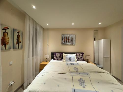 a bedroom with a large bed in a room at Border Bliss - Private Room with Bathroom in a Cozy Home in Kerkrade