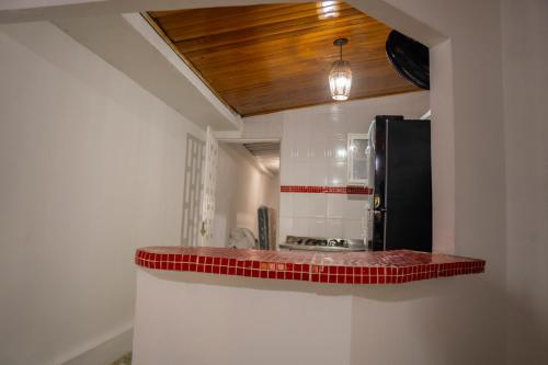 a kitchen with a counter top with red tiles at Casa Claro del Mar in Coveñas