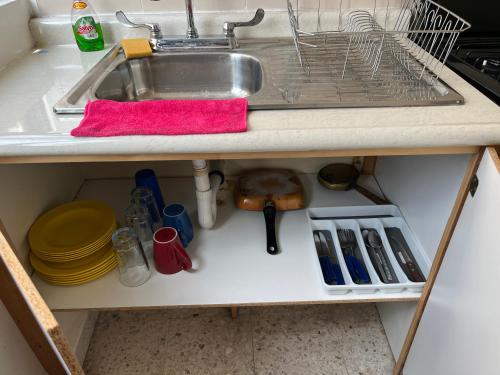 a kitchen counter with a sink and utensils at Depto de Descanso Económico vuelos AICM, conciertos GNP, F1 in Mexico City