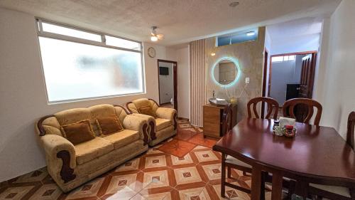 a living room with a couch and a table at Sierra Nevada 2 in Ibarra