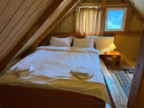 a bedroom with a bed in a attic at Villa Bilugu in Valea de Brazi