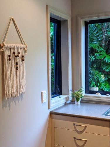 a kitchen with a counter and a window at Pilgrim's Rest in Whangarei