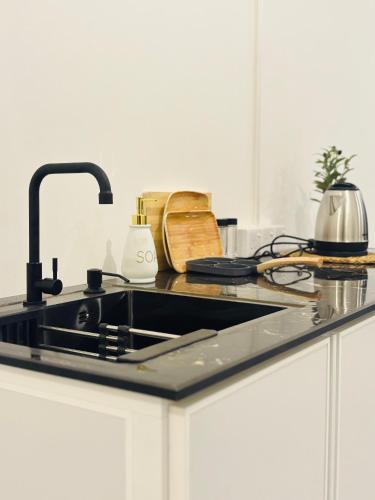a kitchen counter with a sink and a stove at Muthumala Villa in Tangalle