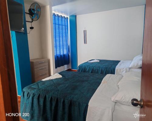 Postel nebo postele na pokoji v ubytování Hotel El Arizal Paracas
