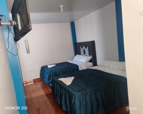 Postel nebo postele na pokoji v ubytování Hotel El Arizal Paracas