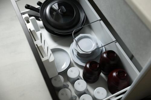 a drawer of a kitchen with some dishes and utensils at 晴レ吉 in Fukuoka