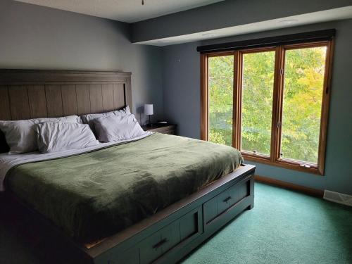 a bedroom with a large bed and a window at Perrysburg On The River in Perrysburg