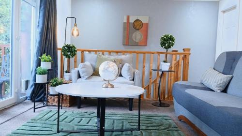 a living room with a couch and a table at Shetcliffe Lodge in Dudley Hill