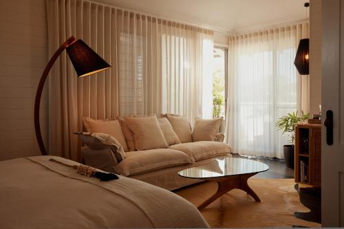 a living room with a couch and a coffee table at 28 Degrees Byron Bay - Adults Only in Byron Bay