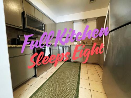 a kitchen with a sign that reads little kitchensleeps eight at Best Location in CS! Amazing Apartment in College Station
