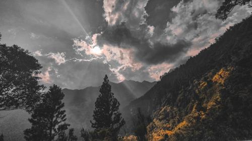 a cloudy sky with trees in the mountains at Eco Wild Glamping Bambarakanda in Walhaputenna