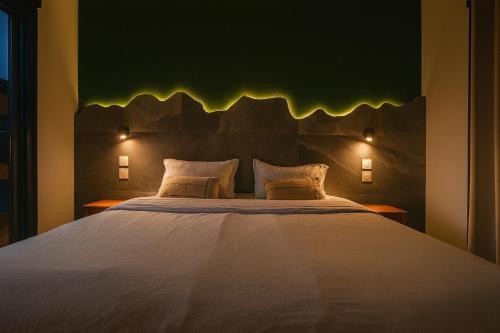 a bedroom with a large bed with lights on it at Villa privée - Piscine, Jacuzzi, Sauna & Hammam in Le Tampon
