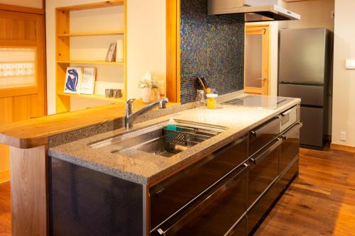 a kitchen with a stainless steel sink in a kitchen at Nagi GIVE 日光 in Nikko