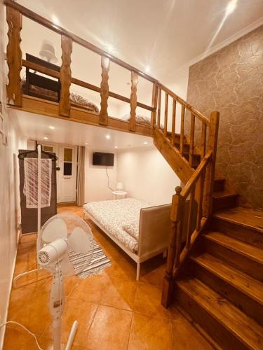 a bedroom with a bunk bed and a staircase at Faro Coast Guest House in Faro