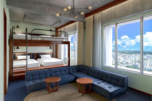 - un salon avec un canapé bleu et des lits superposés dans l'établissement South Gate Hotel Okinawa, à Naha