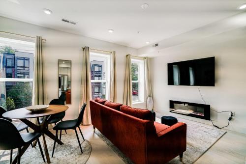 a living room with a couch and a table at The Luxe 8th St Suite in Washington, D.C.