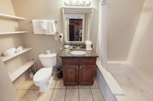 a bathroom with a toilet and a sink and a tub at Condo near Barefoot Landing w beach access in Myrtle Beach