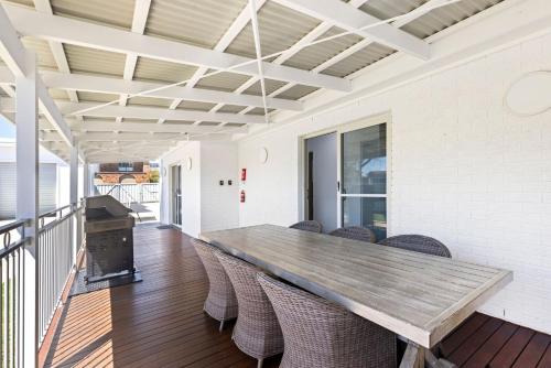 a dining room with a table and chairs at Villa Burra - Pet Friendly - 5 Mins Walk to the Beach in Culburra Beach