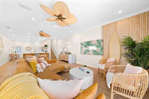 a living room with a couch and a ceiling fan at Luxury Villa, 25 Blocks from the Beach, Hot Tub in Cape Canaveral