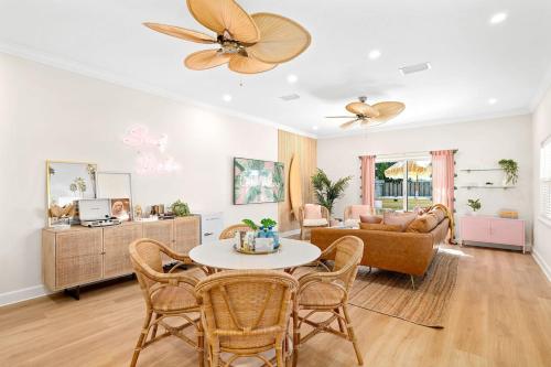 a living room with a table and chairs and a couch at Luxury Villa, 25 Blocks from the Beach, Hot Tub in Cape Canaveral
