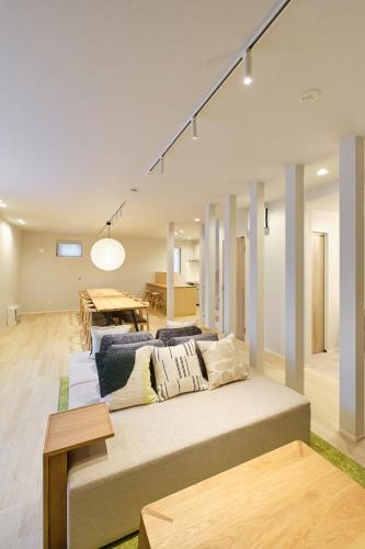 a living room with a couch and a table at 星宿 Asahikawa Miyashita in Asahikawa