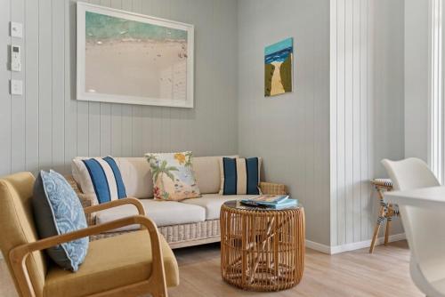a living room with a couch and a table at Ocean Parade 5 - Pool, Spa, Beach, Sleeps 5, Affordable in Coffs Harbour