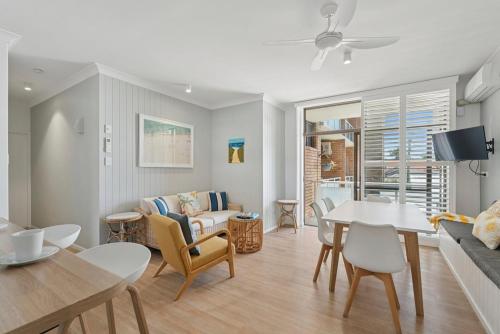 a living room with a table and a dining room at Ocean Parade 5 - Pool, Spa, Beach, Sleeps 5, Affordable in Coffs Harbour