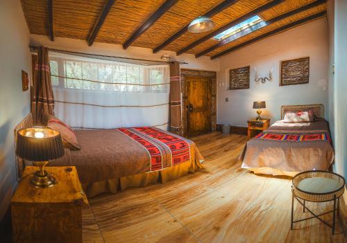 a bedroom with a large bed and a window at Ckoi Atacama Lodge in San Pedro de Atacama