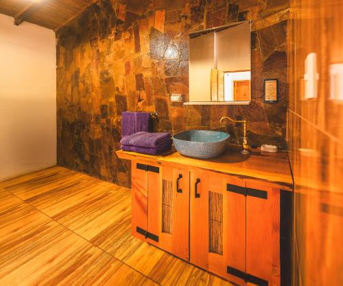 a bathroom with a sink and a mirror at Ckoi Atacama Lodge in San Pedro de Atacama