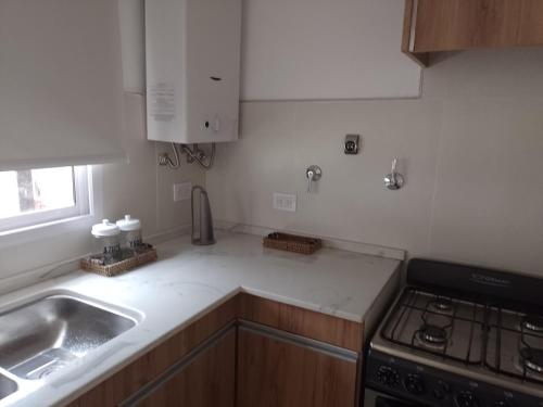 a kitchen with a sink and a stove at Selene in Villa Rumipal