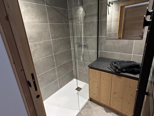 a bathroom with a shower with a glass door at Nouveau ! Appartement de standing 3 chambres avec balcon et parking couvert - FR-1-836-42 in Les Carroz d'Araches