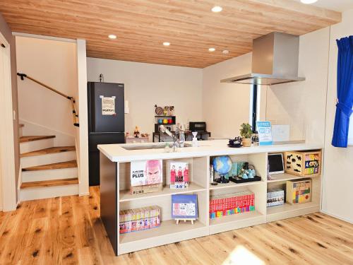 a kitchen with a counter and a refrigerator at 鎌倉江の島 腰越駅徒歩3分海まで5分 2025年新築貸切一戸建て in Kamakura