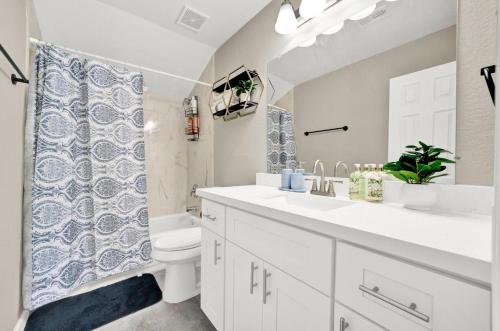 a bathroom with a sink and a toilet and a shower at Elegant 4BD Near NRG stadium, Downtown in Houston