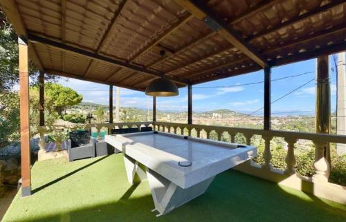 a pool table on a balcony of a house at Eryvazur in Vallauris