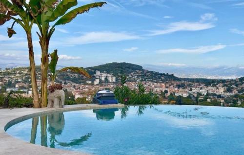 a swimming pool with a view of a city at Eryvazur in Vallauris