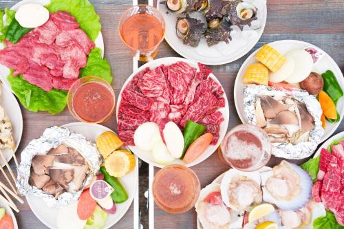 a table with plates of food and glasses of wine at Villa235 in Shirahama