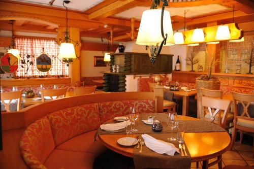 a restaurant with a table and chairs and a dining room at Salzano Basic Rooms Interlaken in Interlaken
