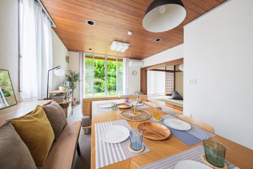 a living room with a table and a couch at Jomo Stay Takasaki 2 -the Garden- in Takasaki